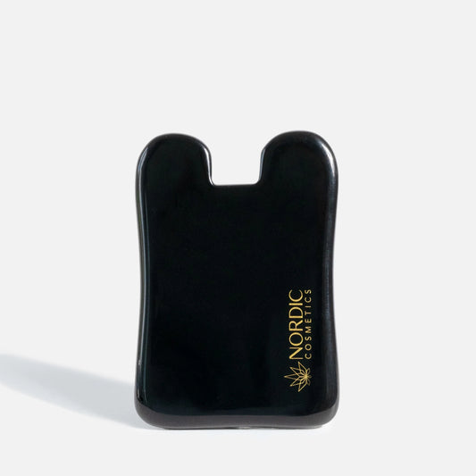 Outil de massage du visage noir avec logo Nordic Cosmetics