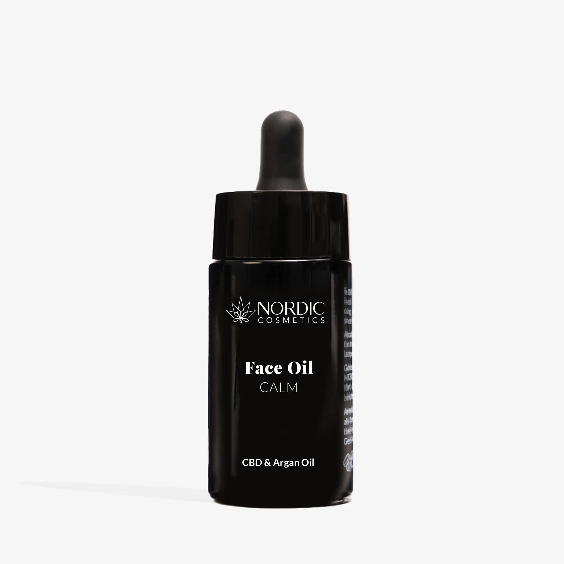 Une huile pour le visage Nordic Cosmetics avec CDB et huile d'argan dans un flacon noir