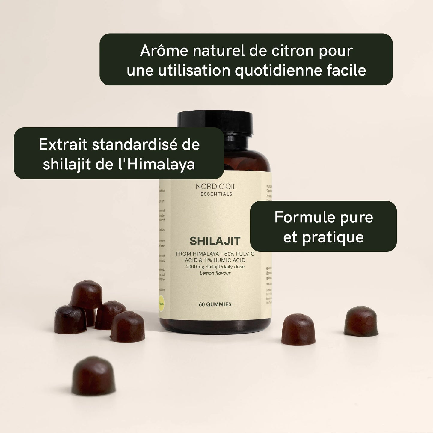 Bouteille de Shilajit Nordic Oil Essentials entourée de gommes brunes sur fond clair