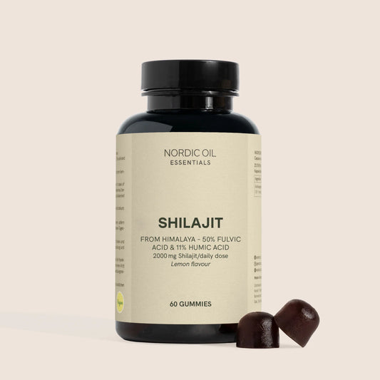 Flacon noir de gommes Shilajit Nordic Oil Essentials, étiquette beige, avec deux gommes à côté.