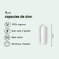 Capsules de zinc blanches avec icônes véganes et mentions sans soja ni gluten, sans sucre et minéraux chélatés sur fond vert pastel.